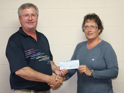 Dale Thacker, chair of the HALO board of directors accepts a cheque for $5,000 from Laurie Haynes of the Bow Island-Foremost Victim Assistance Association.
