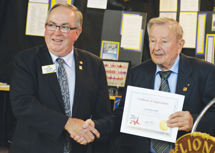 Founding charter member of the Redcliff Lions, Herman Wahl gets a certificate of recognition from Lions Club International president, Dr. Jitsuhiro Yamada.