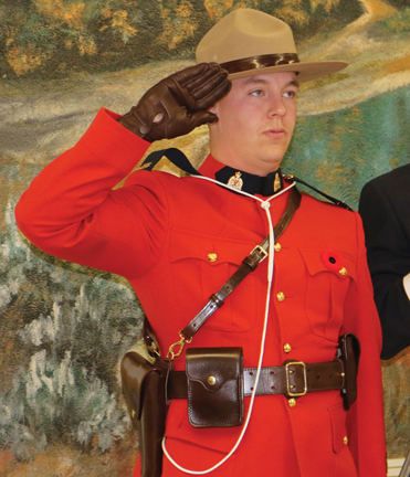 Cst. Andrew Crouse from the Bow Island/Foremost RCMP detachment salutes during the start of the service.