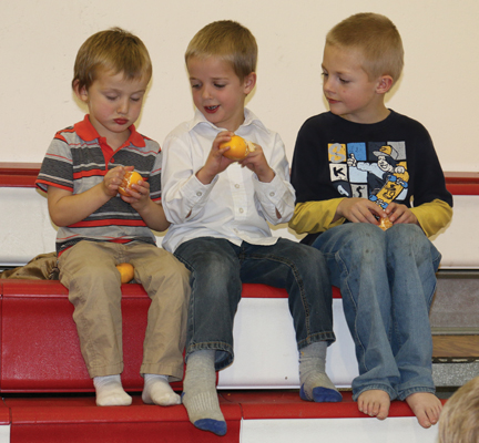 These young boys were enjoying their mandarin oranges while sitting on the top tier of the bleachers at last Friday's fundraiser at Cherry Coulee Christian Academy.