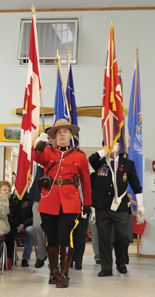 Cst. Andrew Crouse leads the Colour Guard at the Remebrance Day service at the Bow Island Royal Canadian Legion.