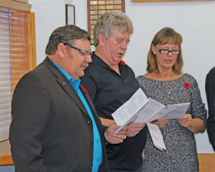 County of Forty Mile councilor Gerald Reimer, along with Paul and Betty Schaufele, join in singing the hymn, "Abide with Me". 