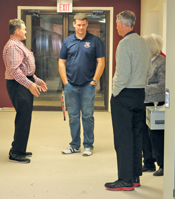 Cherry Coulee Christian Academy principal Mike Daniels (centre) takes guests at the fundraiser on a tour of the new classrooms.
