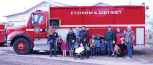 PHOTO BY JAMIE RIEGER- The youngsters from the Etzikom playgroup had a blast when the were treated to a field to the local volunteer fire department. Firefighter, George Mills was more than happy to show them around and even turned on the fire hose for them.