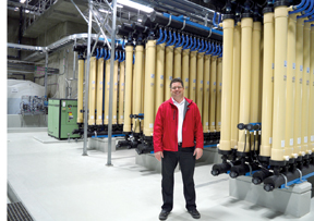 PHOTO BY TIM KALINOWSKI- Jamie Garland, Redcliff's public services director, stands in front of the state-of-the-art Pall Membrane System tubes. the tubes contain hundreds of microfibres each to ensure water purity levels Redcliff has never before seen.