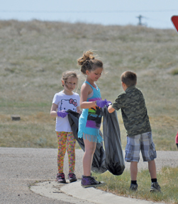 PHOTO BY TIM KALINOWSKI- Grade 2 students do their part to keep their village neat and tidy.