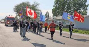 PHOTO BY JAMIE RIEGER- Led by Cst. Andrew Crouse of the Bow Island/Foremost RCMP detachment, members of the Bow Island Royal Canadian Legion, along with donation and award recipients, paraded to the Legion on Thursday evening for a celebration of the 70 anniversary of the local Legion.