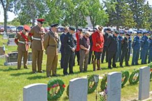 PHOTO BY TIM KALINOWSKI- Guests, including from BATUS, CFB Suffield, RCMP, and cadets joined Redcliff Legion members in a moment of silence during the Decoration Day ceremony held Sunday at the Redcliff cemetery.