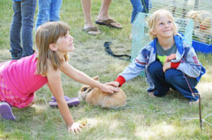 Photo by Tim Kalinowski- These young girls were all smiles at the petting zoo. 