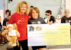 Photo by Tim Kalinowski- Donna Serr, president of the local Children's Wish Foundation, accepts a cheque from the student Cheyanne Zorn.