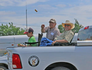 Photo by Jamie Rieger- County of Forty Mile reeve, Bryne Lengyel (right) and councilor Ron Harty ride on the County float. Harty is pictured throwing a treat to the photographer so she doesn't feel left out!