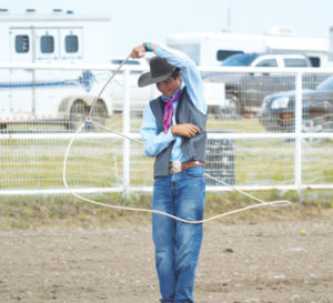 Photo by Tim Kalinowski- Cooper Resch gives a trick-roping demonstration for the crowd.