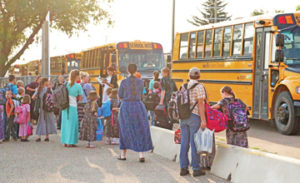 Photo by Jamie Rieger- Burdett School prinicipal Laurie Cooper calls out the names of her students as the board their buses at Bow island Elementary to head to Burdett School on the first day of classes last week.