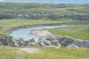 Photo by Tim Kalinowski- Kids play amongst the hoodoos while beach goers relax in the distance.