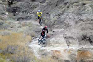 Photo by Tim Kalinowski- Approimately 50 bikes came out for the first annual Test for Humanity race in Redcliff on Saturday. Pictured: Phil Rogers (top) and Justin Kuryluk of Medicine Hat challenge the Redcliff coulees.
