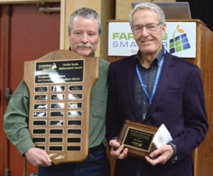Photo by Tim Kalinowski- Lethbridge area farmer Ike Lanier (right) receives the 2016 Orville Yanke Award from Rob Runne at the Farming Smarter conference in Medicine Hat. 