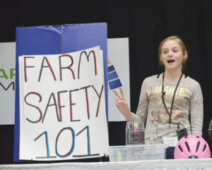Photo by Tim Kalinowski- Local 4H member Evi Neubauer delivers a speech on farm safety to Farming Smarter delegates last Thursday at the Medicine Hat Lodge,